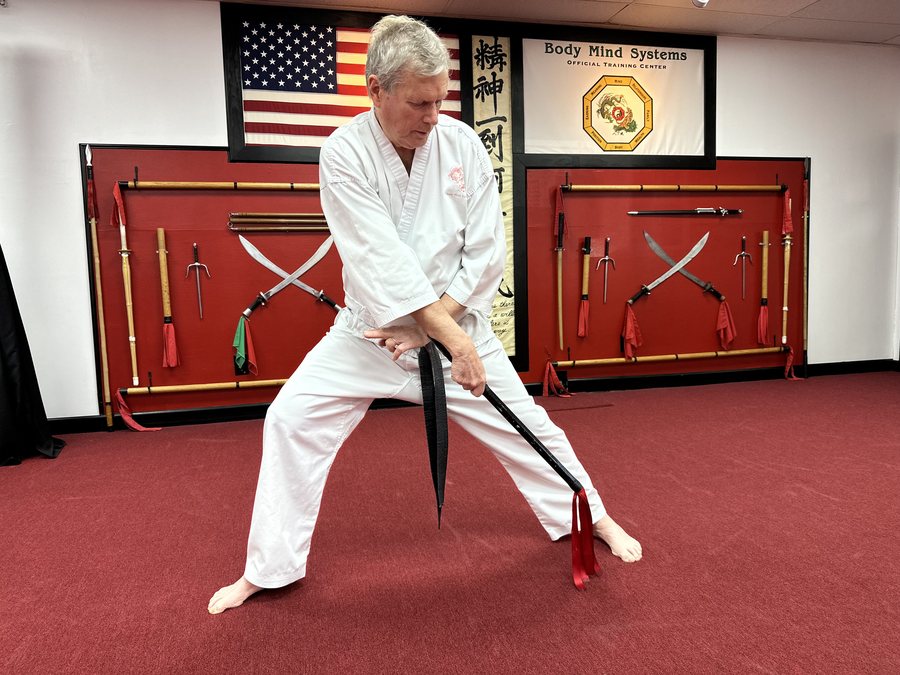 Senior student training with a chain whip